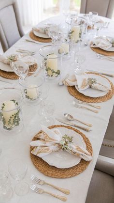 the table is set with place settings for dinner