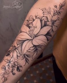 a black and white flower tattoo on the arm