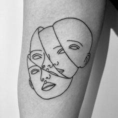 a woman's leg with three faces drawn on it and one has a bandage around her head