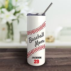 a baseball mom tumbler with a straw in it