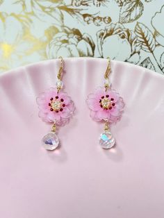 These exquisite handmade earrings feature delicate pink cherry blossom Japanese Sakura flowers adorned with Swarovski crystal teardrops, adding a touch of elegance and sparkle. Perfect for those who appreciate the beauty of nature and the artistry of handmade jewelry, these kawaii earrings make a thoughtful and enchanting gift for her on any special occasion.  Capture the essence of springtime and add a touch of whimsy to any outfit with these enchanting accessories. Earrings Kawaii, Sakura Flowers, Japanese Sakura, Pink Cherry Blossom, Kawaii Earrings, Sakura Flower, Cloth Flowers, Teardrop Dangle Earrings, Pink Cherry