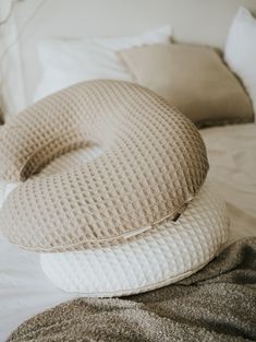 two pillows are stacked on top of each other in the shape of a donut