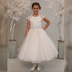 Sweetie Pie Collection Communion Dress Has A Satin Bodice With Illusion Half Cap Sleeves. Lace From Top Of Dress Flowing Onto Top Of Skirt. Rhinestones And Beadwork At Waistline. Tulle Skirt With Scattered Lace Patchwork. Designer First Communion Dresses, Comunion Dress, Communion Dresses Lace, Organza Flower Girl Dress, Girls First Communion Dresses, Confirmation Dresses, Girls Communion Dresses, Holy Communion Dresses, Special Occasion Gowns