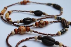 Beach Necklace With Brown Round Beads, Handmade Brown Long Beaded Necklaces, Handmade Brown Beaded Long Necklaces, Adjustable Brown Beaded Necklaces Nature-inspired, Handmade Brown Beaded Long Necklace, Bohemian Brown Necklace With Wooden Beads, Bohemian Beaded Necklaces As Gift, Bohemian Brown Necklace With Natural Variations, Bohemian Beaded Necklace With Natural Variations