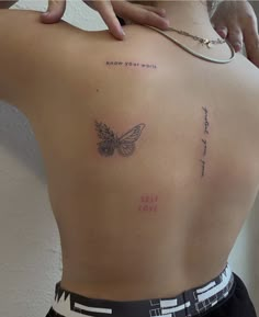 a woman with a butterfly tattoo on her back and the words i love you mom written in cursive writing