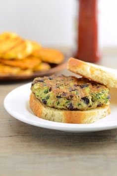 there is a sandwich with broccoli on it and some crackers next to it