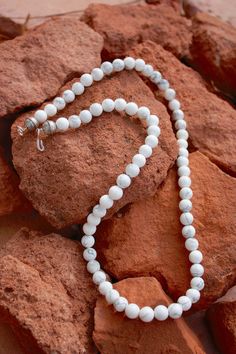 "Natural white buffalo howlite & sterling necklace. Made by native artisan. Gorgeous white buffalo beads (howlite) w/sterling hook and eye and native sterling bead at the end. -different sizes available 16\"-24\" -8mm beads -has native stamped sterling beads at the end Please note- the earrings in the picture match the necklace beautifully and are available to purchase separately. Here is a link to them- https://www.etsy.com/listing/667527971/mindfulness-gift-gemstone-earrings?ref=related-7 Adjustable White Turquoise Necklace With Natural Stones, White Turquoise Necklace With Natural Stones, Adjustable, Howlite Gemstone Beads Necklace, Hand-strung Howlite Jewelry With Round Beads, Hand-strung Round Howlite Beads Jewelry, Adjustable Howlite Gemstone Bead Necklace, Southwestern White Round Beads Jewelry, Southwestern White Round Bead Jewelry, Southwestern Style White Round Beads Jewelry