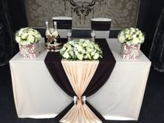 the table is set up with flowers and champagne bottles on it, along with other decorations