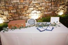 the table is set up with place settings for guests to sit down and sign their names