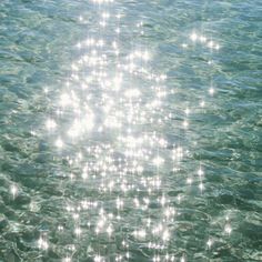 the sun shines brightly on the water as it reflects off its surface in this photo