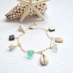 "This beautiful ocean inspired charm bracelet has an assortment of shells and cultured sea glass dangling from a textured cable chain and finished with a tiny gold filled starfish at the end. This bracelet is meant to dangle so I add 1/2\" to the length you order. Please allow for variations in size and shape of shells and sea glass." Beach Ocean-inspired Charm Bracelet, Bohemian Charm Bracelet For Beach With Lobster Clasp, Bohemian Charm Bracelet For The Beach, Ocean-inspired Starfish Charm Bracelet For Beach, Ocean Inspired Jewelry, Ocean Inspired, Beautiful Ocean, Ocean Inspiration, Honolulu