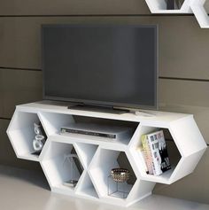 a white entertainment center with shelves and a flat screen tv mounted on it's side