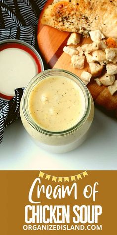 chicken soup in a small glass jar next to bread on a cutting board and with the words cream of chicken soup written above it