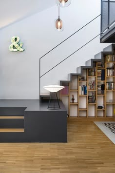 a room that has some bookshelves and a lamp on the wall in it