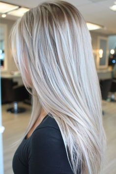 Icy Ash Blonde Straight Hair on a woman with blonde hair in a hair salon, side view.