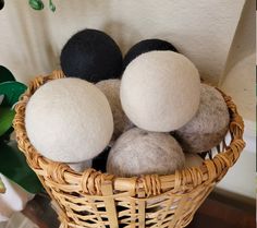 four wool balls in a wicker basket