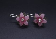 Handcrafted of nickel-free tarnish resistant silver-plated wire and lucite beads, these flower earrings are a delight to wear! Fun, unique, and cheerful! These earrings may be made to order. The earrings you receive will be carefully crafted with some minor artistic variation. Earrings come in a gift box ready for giving and are shipped in a bubble mailer to safeguard during shipping. Costume Jewelry Care and Storage * Apply cosmetics, hair products, lotions, perfumes, and powders prior to donning your jewelry. * Prevent exposure to moisture * Remove jewelry before showering, swimming, sunbathing, and exercising * Remove jewelry before bedtime * Keep out of direct sunlight * Metals may tarnish over time due to oxygen and natural body oils * To reduce tarnishing, store jewelry in a sealed b Adjustable 3d Flower Earrings, Adjustable Nickel-free Pink Flower Earrings, Pink Flower-shaped Metal Earrings, Whimsical Pink Flower-shaped Jewelry, Vintage Pink Nickel-free Flower Earrings, Vintage Pink Flower-shaped Earrings, Lucite Flower Earrings, Bubble Mailer, Green Flowers