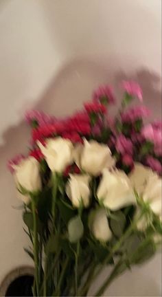 a bunch of white and pink flowers in a vase