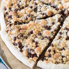 a pizza with chocolate chips and crumbs on it