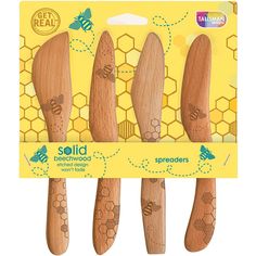 four wooden utensils with bees on them in a package for $ 3 99