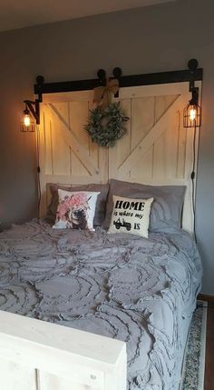 a bedroom with a bed made up and lights on the headboard are hanging above it