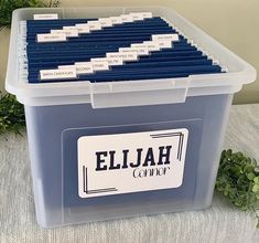 a plastic container filled with blue files on top of a table