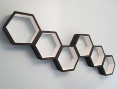 three hexagonal mirrors mounted to the wall