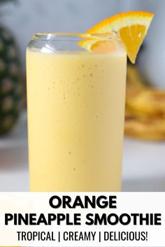 orange pineapple smoothie in a tall glass with an orange slice on top and the words, orange pineapple smoothie tropical i creamy delicious