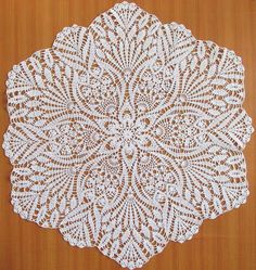 a white doily on a wooden surface