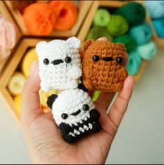 two small crocheted animals are held in their hands