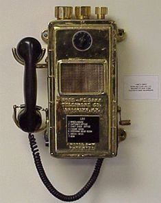 an old fashioned phone is hanging on the wall