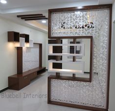 an empty room with white walls and wooden furniture on display in the center, surrounded by decorative panels