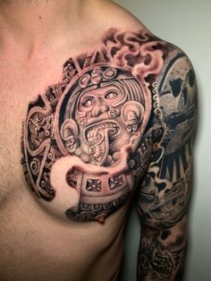 a man's chest with tattoos on it