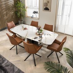 a dining room table with chairs and a plant in the center on top of it