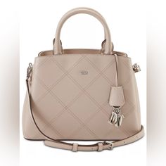 Color Available: Beige Bag Dimensions: 11” W X 8” H X 4-1/2” D ( Width Is Measured Across The Bottom Of The Bag) 1.5 Lbs. Approx. Weight The Silhouette Is Based Off 5’9” Model 4” L Top Handles 23” L Adjustable Strap Zipper Closure Silver-Tone Hardware Back Zip And Footed Bottom Triple Compartment Interior Zip And Slip Pockets Faux Leather Dkny Paige Satchel, Dkny Bags, Dkny Bag, Beige Bag, Diamond Stitch, Rebecca Minkoff Hobo, Handbag Accessories, Convertible, Satchel