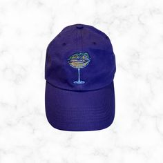 a purple hat with an image of a martini glass on the front, and text that reads limited edition