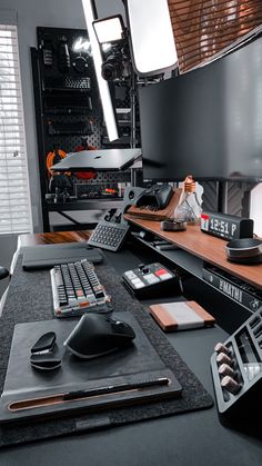 there is a desk with several computers and mouses on it, along with other office supplies