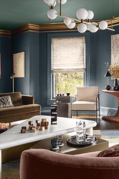 a living room with blue walls and furniture