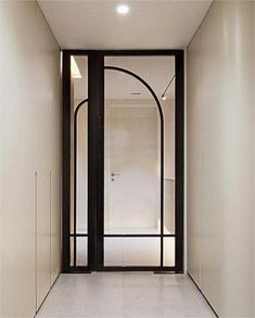 an empty hallway with black and white doors