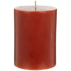 an orange colored candle with a wooden stick sticking out of it's center, on a white background