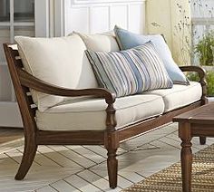 a living room filled with furniture and pillows