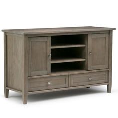 an entertainment center with two drawers and one door on each side, in grey wood