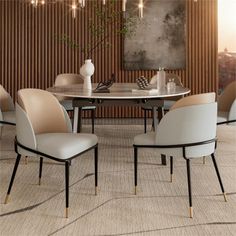 a dining room table with four chairs and a vase on the table in front of it