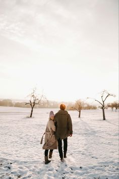 two people are walking in the snow together