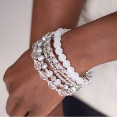 Infused With Silver Accents, A Glassy Collection Of White And Metallic Crystal-Like Beads Are Threaded Along Stretchy Bands Around The Wrist For A Whimsically Layered Look. Sold As One Set Of Six Bracelets. Bracelets Set, Jewelry Crystal, Stretchy Bracelets, Paparazzi Jewelry, One Set, Silver Accents, White Beads, Layered Look, Bracelet Set