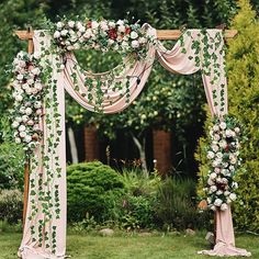 a wedding arch decorated with flowers and greenery