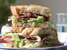 a sandwich is stacked on top of each other with meat, lettuce and cheese