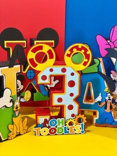 mickey mouse and friends are standing next to each other in front of the number four