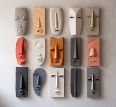 several different types of masks are arranged on the wall