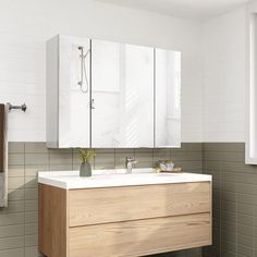 a bathroom with a sink, mirror and towel rack on the wall next to it